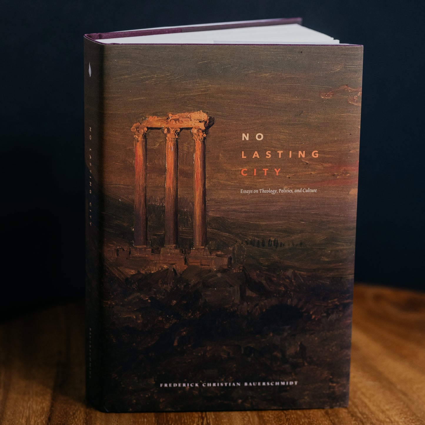 No Lasting City by Frederick Christian Rauerschmidt featuring a dark cover with ancient ruins artwork, spiritual essays on theology, culture, and providence, recommended for adult readers, Word on Fire Academic, hardcover 9781685780463