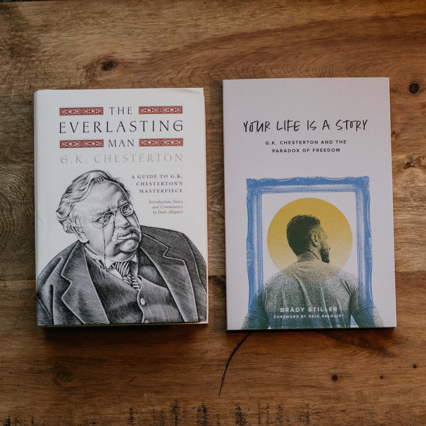Two books on a wooden surface featuring "The Everlasting Man Bundle" by G.K. Chesterton