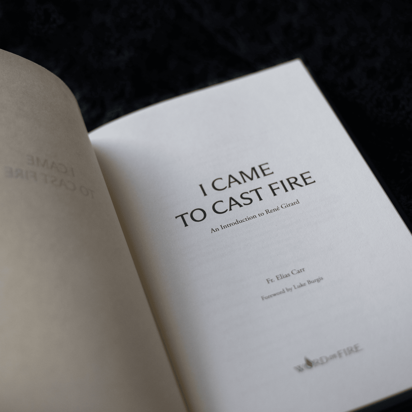 Open book showing the title page of "I Came to Cast Fire," an introduction to René Girard by Fr. Elias Carr, book on mimetic theory, anthropology, hardcover 9781685781668