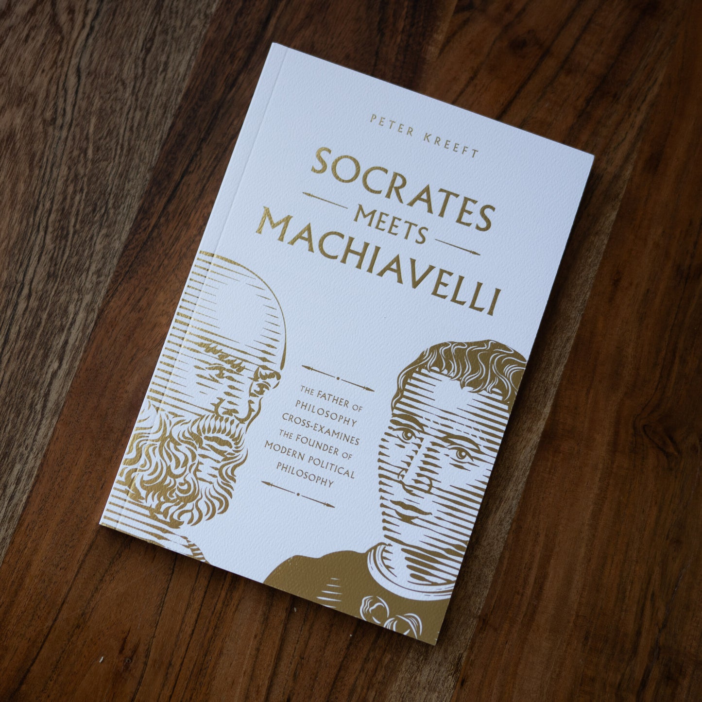 Book cover of Socrates Meets Machiavelli by Peter Kreeft showing illustrative portraits of Socrates and Machiavelli in gold and white, philosophy book 9781685782139