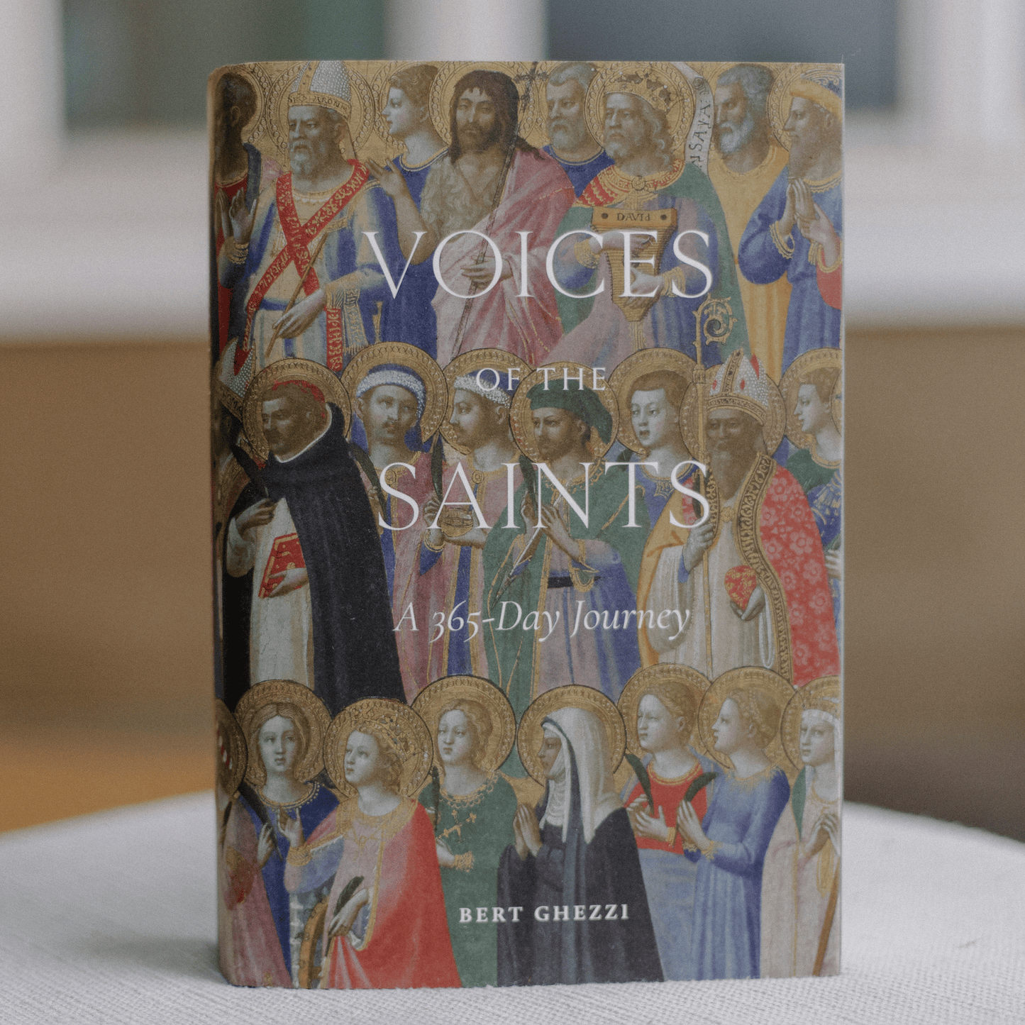 Cover of "Voices of the Saints: A 365-Day Journey" featuring classical saintly figures artwork, authored by Bert Ghezzi, daily devotional for Catholics, hardcover 9781685781163