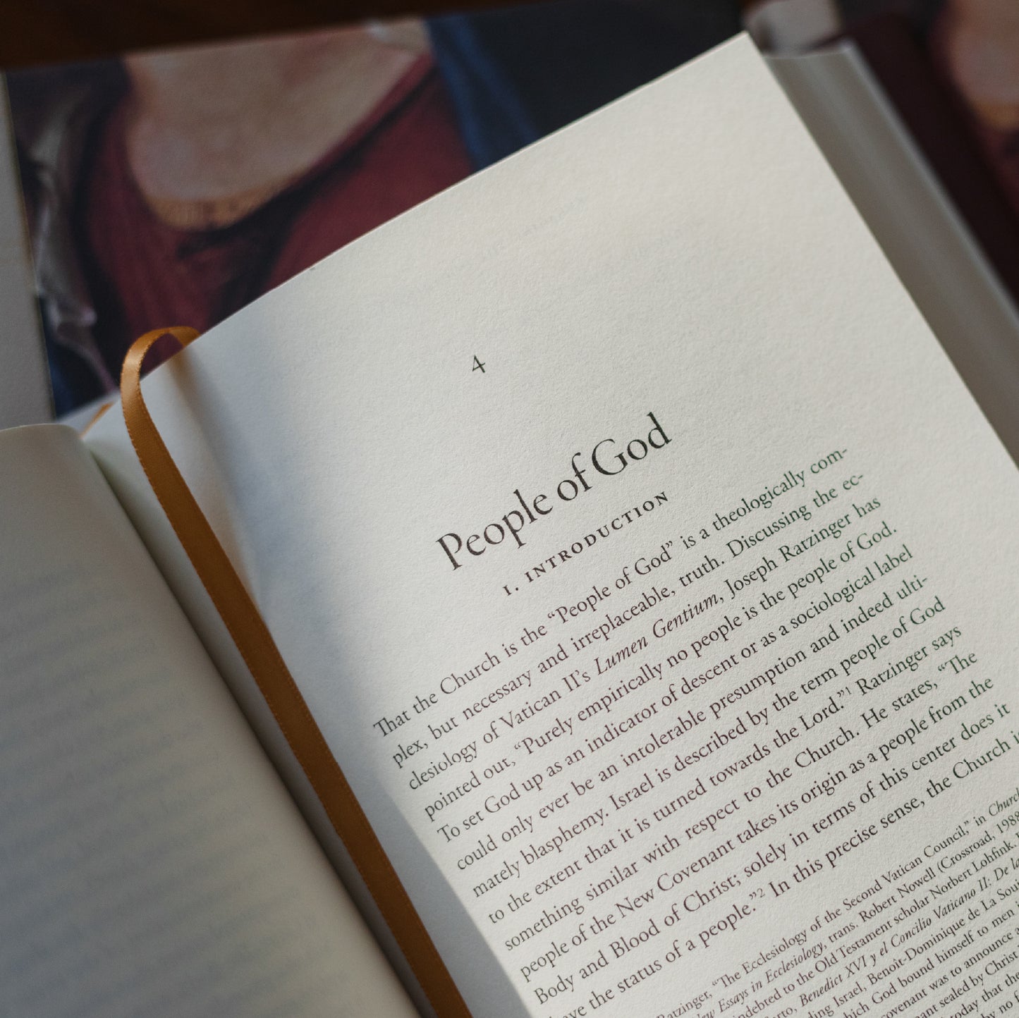 Open book showing a page from "Engaging the Doctrine of the Church" by Matthew Levering, a theology book focused on Catholic church doctrine, hardcover 9781685782221, published by Word on Fire Academic