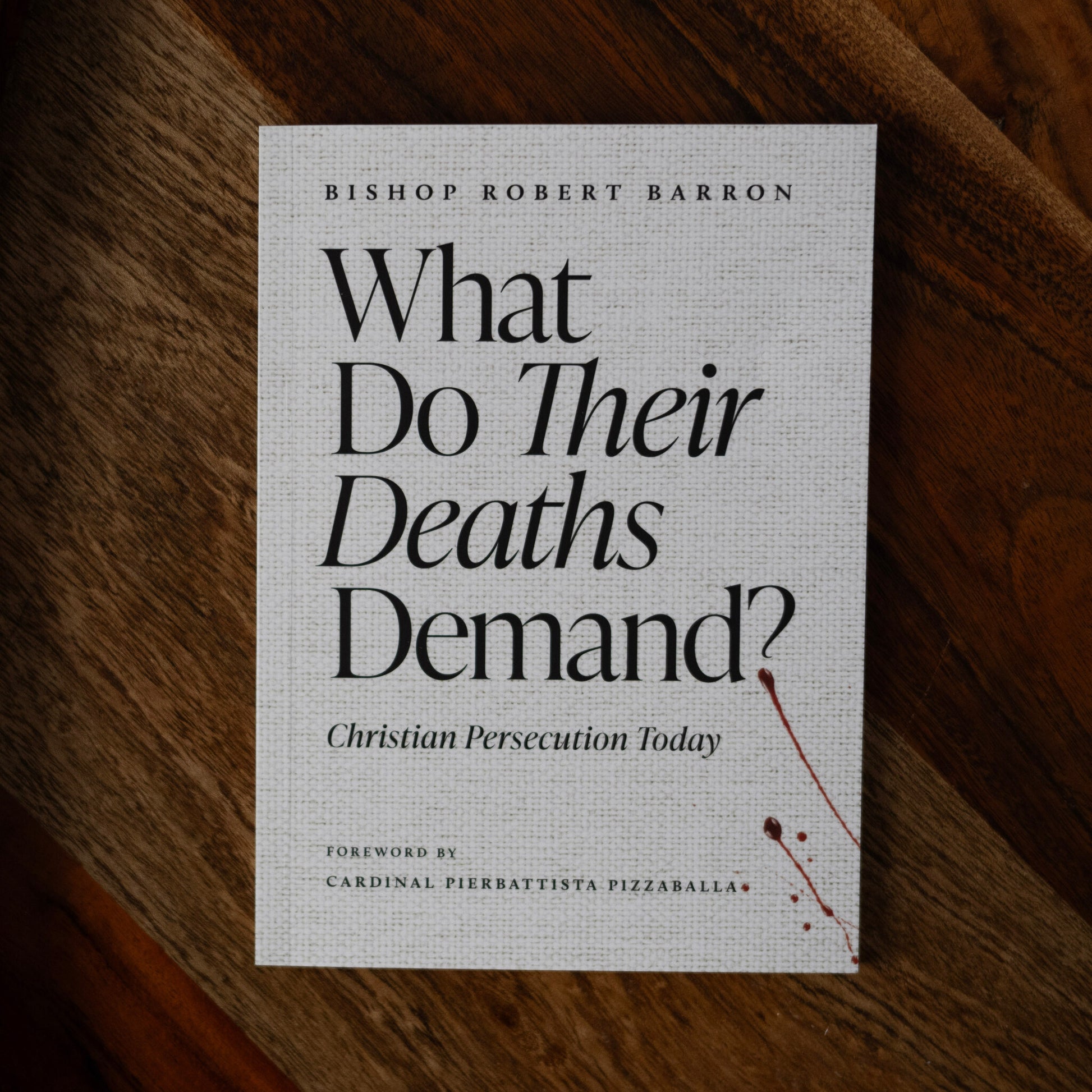 Book cover titled "What Do Their Deaths Demand?" by Bishop Robert Barron, focusing on Christian persecution today, with a foreword by Cardinal Pierbattista Pizzaballa, paperback 9781685783754