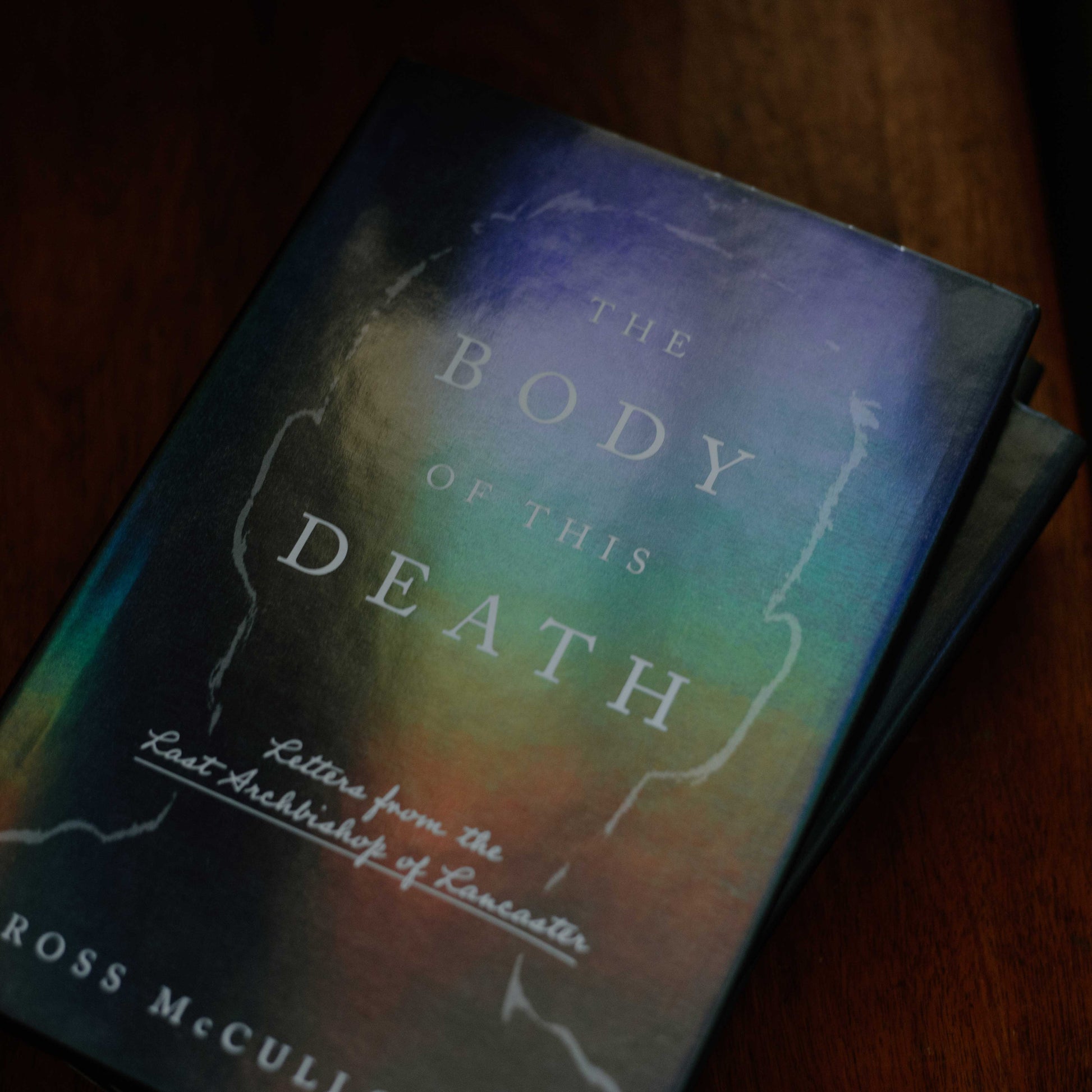 Cover of the book The Body of This Death with holographic cover, fiction book, hardcover 9781685782597