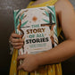 A child in a yellow dress holding "The Story of All Stories," a story Bible for young Catholics by Emily Stimpson Chapman, illustrated Catholic children's bible, suitable for children ages 7-13, hardcover 9781685782214 