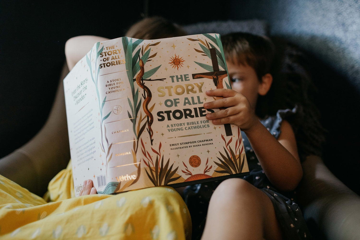 Child reading The Story of All Stories, a story Bible for young Catholics, hardcover edition, suitable for ages 8 and up