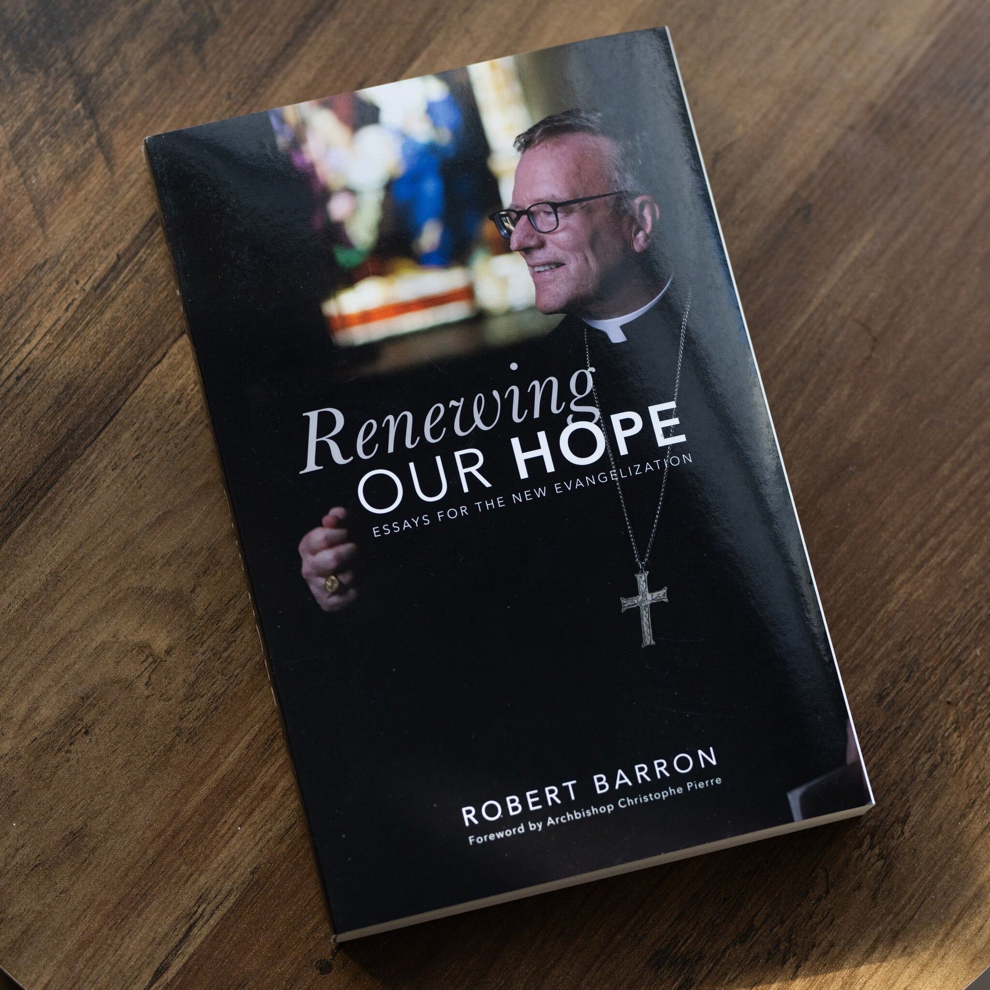 Book titled "Renewing Our Hope: Essays for the New Evangelization" by Robert Barron, with foreword by Archbishop Christophe Pierre, emphasizing Catholic spiritual growth and evangelization