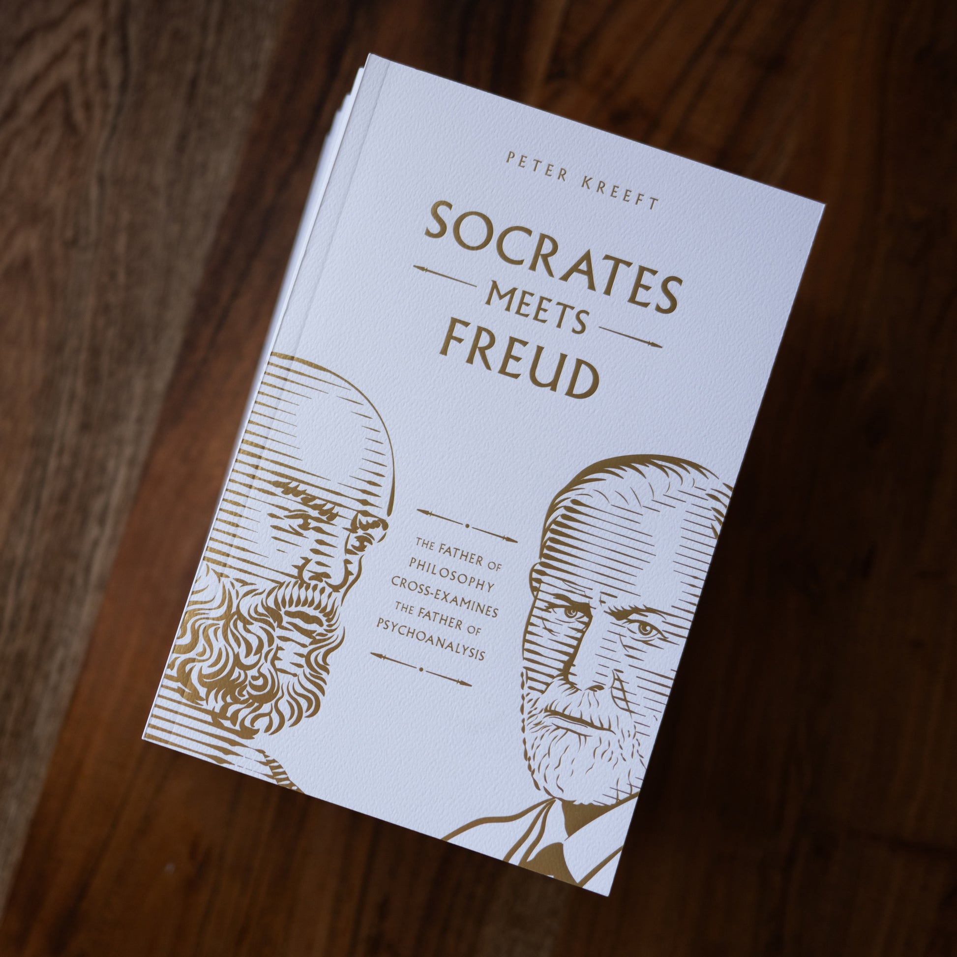 Book cover of Socrates Meets Freud by Peter Kreeft, featuring illustrated portraits of Socrates and Freud in gold lines on a white background, philosophy book, 9781685782153