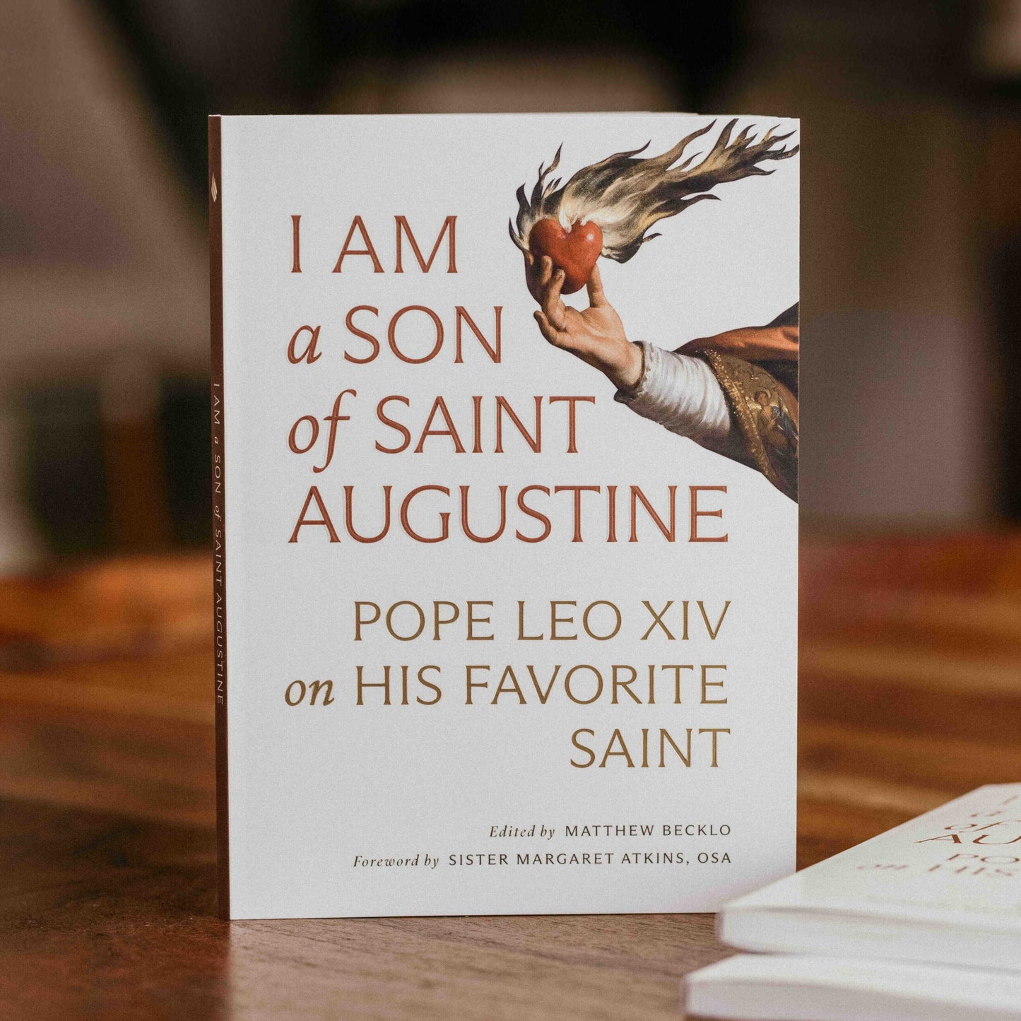 I Am a Son of Saint Augustine book cover showing a hand holding a flaming heart, edited by Matthew Becklo and foreword by Sister Margaret Atkins, paperback 9781685783198