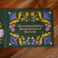 Open page from Magnificat Canticle of Mary featuring colorful floral illustrations surrounding the text "My soul proclaims the greatness of the Lord," illustrated by Tricia Dugat, board book 9781685781521
