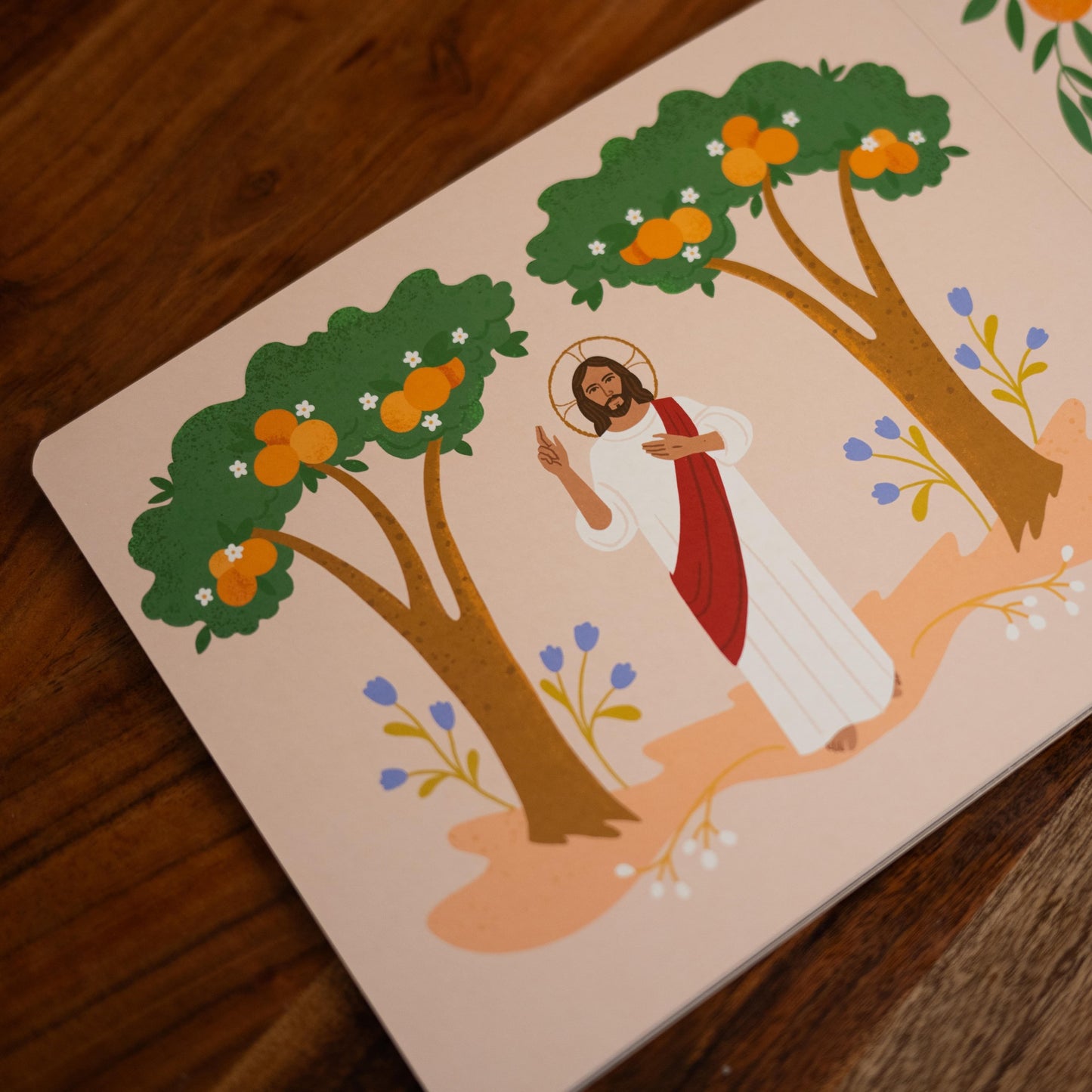 Illustration of Jesus standing between two trees with orange fruit and purple flowers, part of Magnificat Canticle of Mary, illustrated by Tricia Dugat, board book 9781685781521
