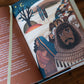 The Story of All Stories book open to an illustrated page showing biblical characters under a night sky with text on the left page, by Emily Stimpson Chapman, illustrated Catholic children's bible, suitable for children ages 7-13, hardcover 9781685782214 