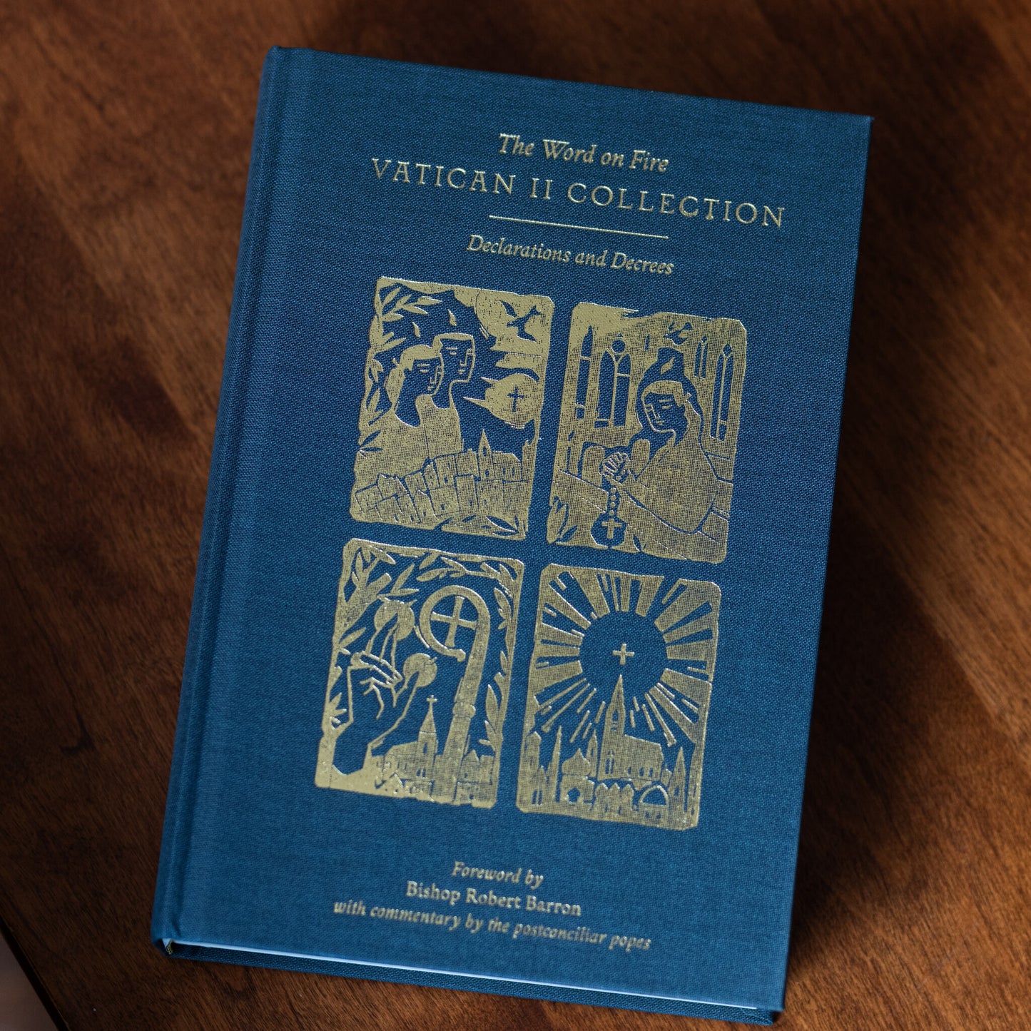 The Vatican II Bundle book with a green hardcover featuring gold embossed illustrations and text, including contributions by Bishop Robert Barron and Matthew Levering