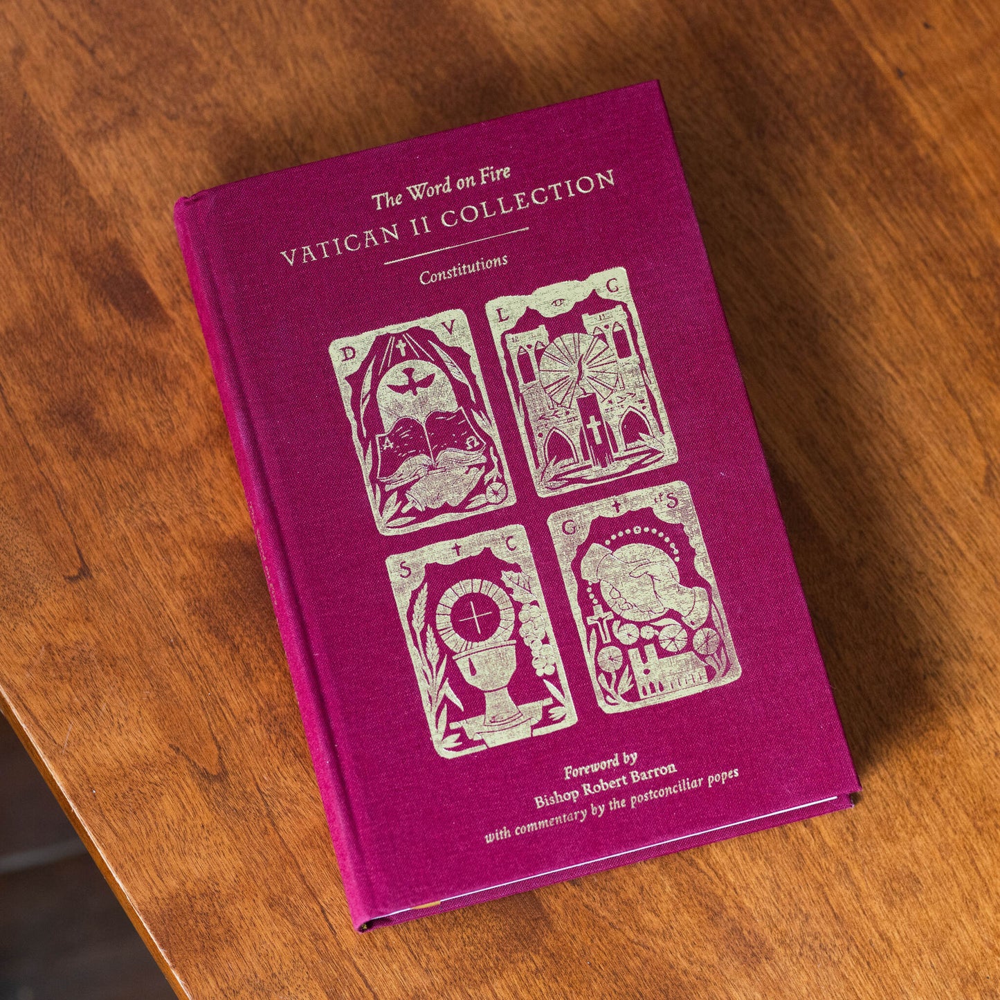The Vatican II Bundle hardcover book in deep red with gold-embossed religious illustrations on the cover, foreword by Bishop Robert Barron, edited by Matthew Levering