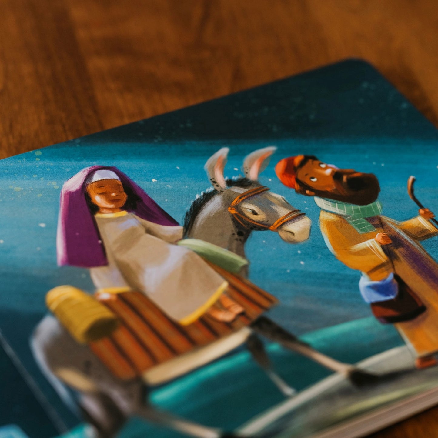 Illustrated scene from The Song of Zechariah showing biblical characters Mary and Joseph riding a donkey under a starry sky