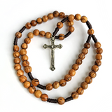 The Word on Fire Rosary featuring polished wooden beads with natural grain and a detailed metal crucifix, designed for Catholic spiritual growth and prayer.